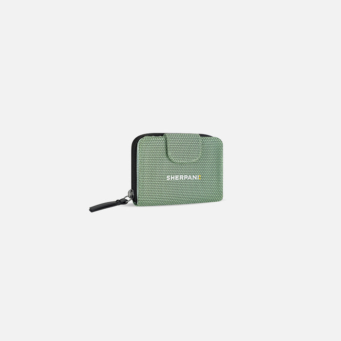 A Sherpani Barcelona Aloe Mist Green Anti-theft RFID Mini Wallet, 3/4 view showing clasp on white background.  #color_aloe-mist-green