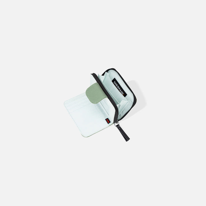 A Sherpani Barcelona Aloe Mist Green Anti-theft RFID Mini Wallet, above view showing inside wallet on white backdrop.  #color_aloe-mist-green