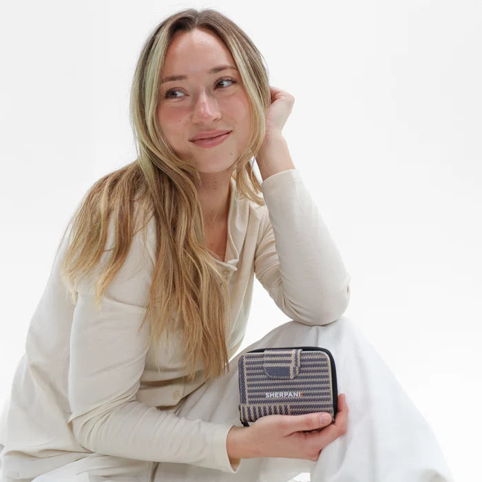Woman holding a Sherpani Barcelona Passport Anti-Theft Mini Wallet on white backdrop.  #color_passport-print