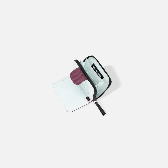 A Sherpani Barcelona Smoky Orchid Anti-theft Mini Wallet, above view showing inside wallet on white backdrop.    #color_smoky-orchid-pink