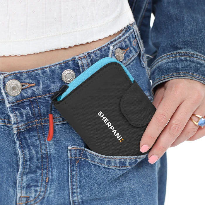Woman holding a Sherpani Barcelona Chromatic Black RFID Mini Wallet on white backdrop. #color_chromatic-black