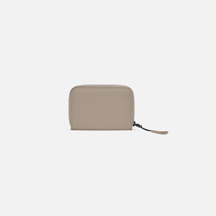 A Sherpani Barcelona Dune RFID Mini Wallet, back view on white background. #color_dune-tan