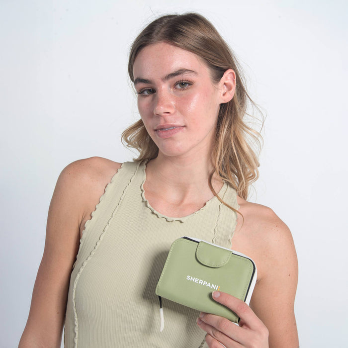 Woman holding a Sherpani Barcelona Palm Green RFID Mini Wallet on white backdrop.  #color_palm-green
