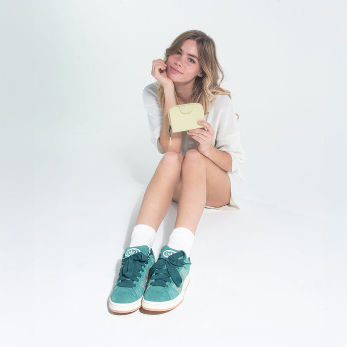 Woman holding a Sherpani Barcelona Sol Yellow RFID Mini Wallet on white backdrop. #color_sol-yellow