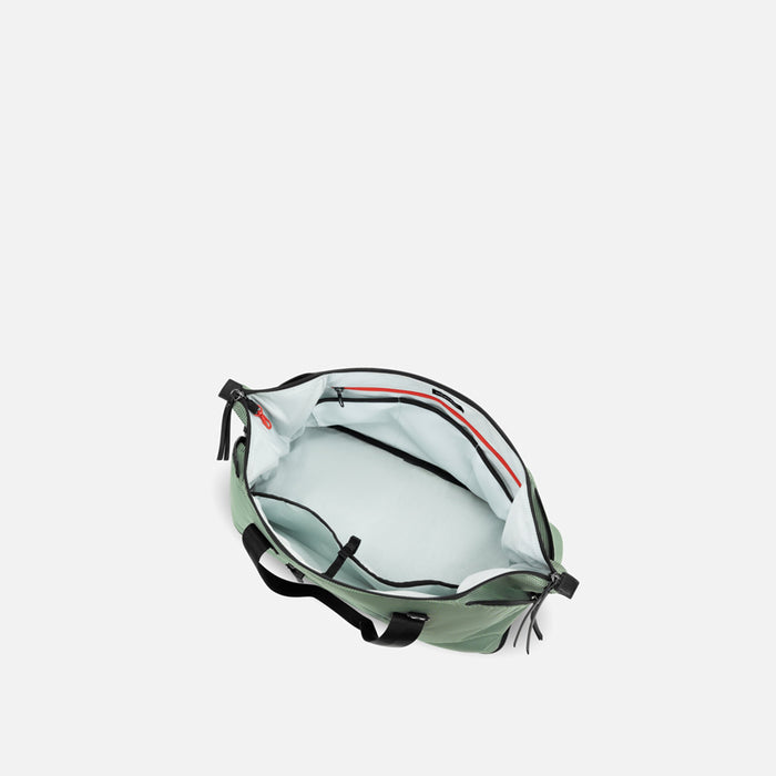 A Sherpani Boston Aloe Mist Green Weekender, above view showing inside main pocket on white backdrop. #color_aloe-mist-green