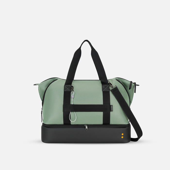 A Sherpani Boston Aloe Mist Green Anti-theft Weekender, back view showing luggage strap & strap options on white backdrop. #color_aloe-mist-green