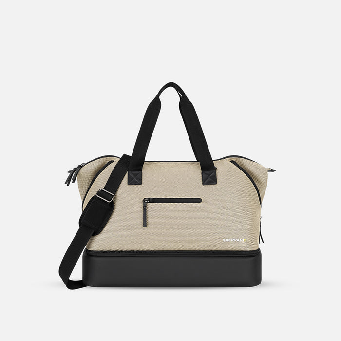 A Sherpani Boston Straw Beige Anti-theft Weekender, front view showing strap and lockable pocket on white background. #color_straw-beige