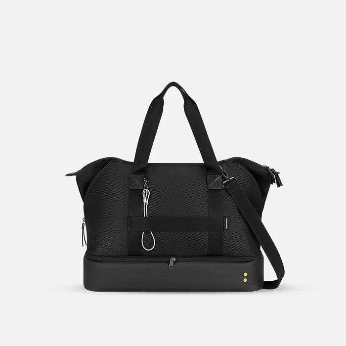 A Sherpani Boston Carbon Black Anti-theft Weekender, back view showing luggage strap & strap options on white backdrop.  #color_carbon-black