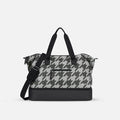 A Sherpani Boston Houndstooth Anti-theft Weekender, front view showing lockable pocket & strap options on white backdrop.  #color_houndstooth-print