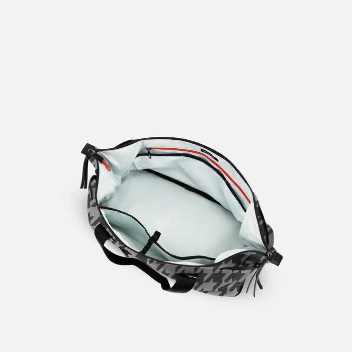 A Sherpani Boston Houndstooth Anti-theft Weekender, above view showing inside main pocket on white backdrop.  #color_houndstooth-print