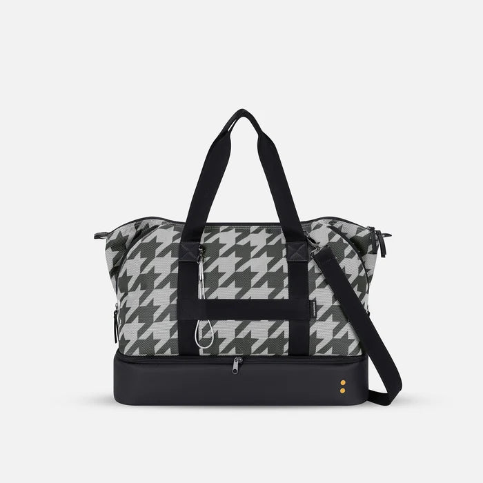 A Sherpani Boston Houndstooth Anti-theft Weekender, back view showing luggage strap & strap options on white backdrop.  #color_houndstooth-print