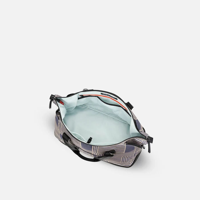 A Sherpani Boston Passport Anti-theft Weekender, above view showing inside main pocket on white backdrop.  #color_passport-print