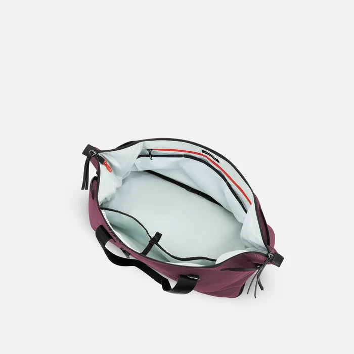 A Sherpani Boston Smoky Orchid Anti-theft Weekender, above view showing inside main pocket on white backdrop.  #color_smoky-orchid-pink
