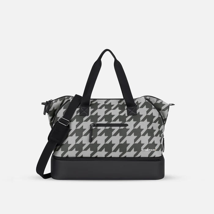 A Sherpani Boston Houndstooth Anti-theft Weekender, front view showing lockable pocket & strap options on white backdrop.  #color_houndstooth-print