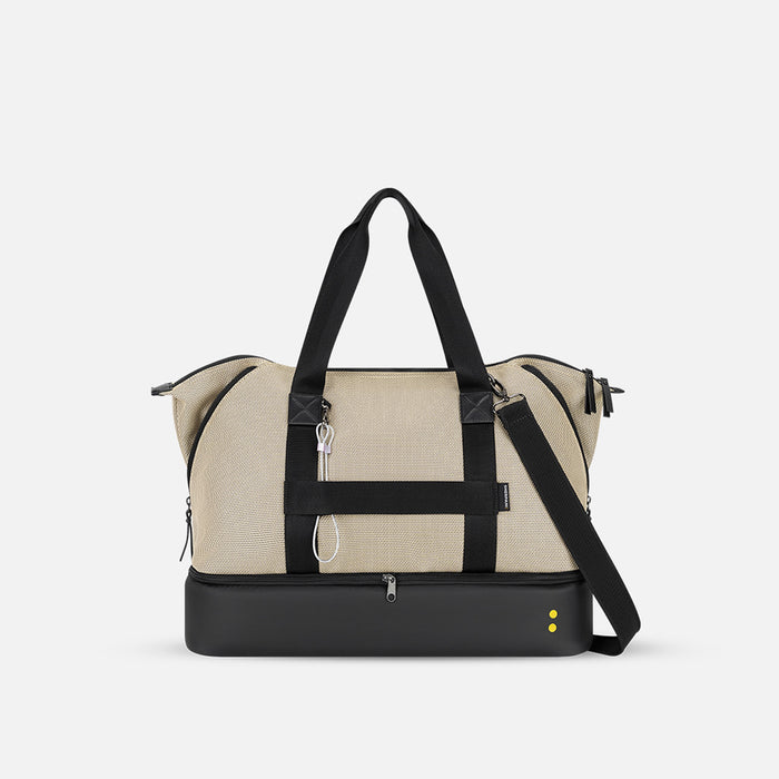 A Sherpani Boston Straw Beige Anti-theft Weekender, back view showing luggage strap & strap options on white backdrop. #color_straw-beige