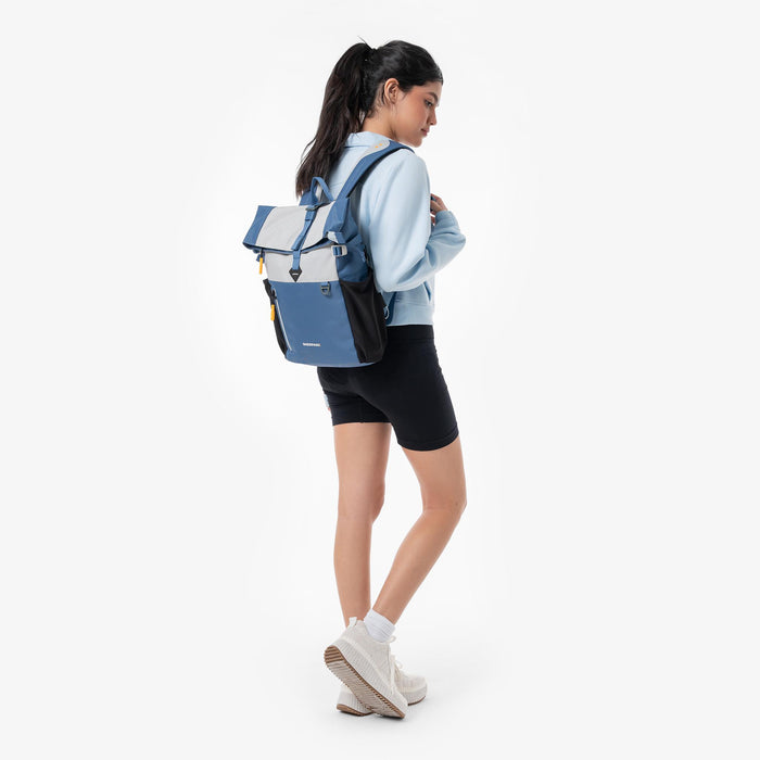 Woman wearing a Sherpani Cabo Seastone Day Pack against a white background. #color_seastone