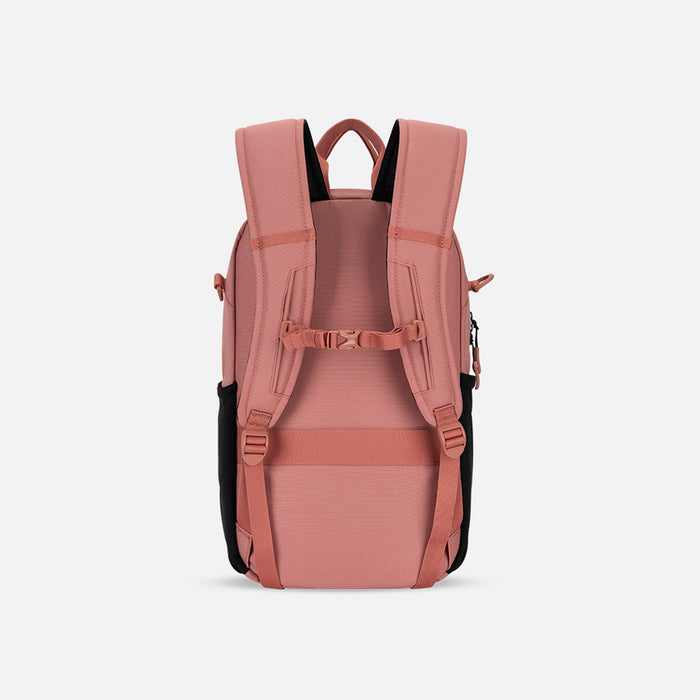 A Sherpani Camden Desert Pink Backpack, back view showing the shoulder strap and a luggage strap on a white background. #color_desert-pink