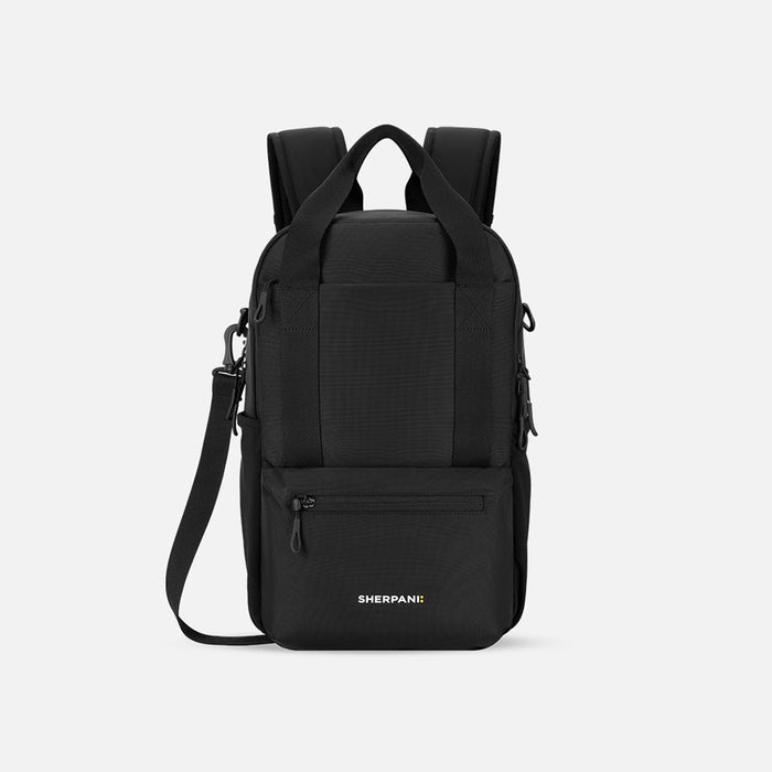 A Sherpani Camden Raven Black Backpack, front view showing various pockets and strap options on white backdrop.  #color_raven-black