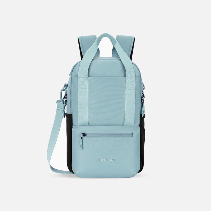 A Sherpani Camden Surf Blue Backpack, front view showing various pockets and strap options on white backdrop.  #color_surf-blue