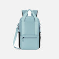 A Sherpani Camden Surf Blue Backpack, front view showing various pockets and strap options on white backdrop.  #color_surf-blue