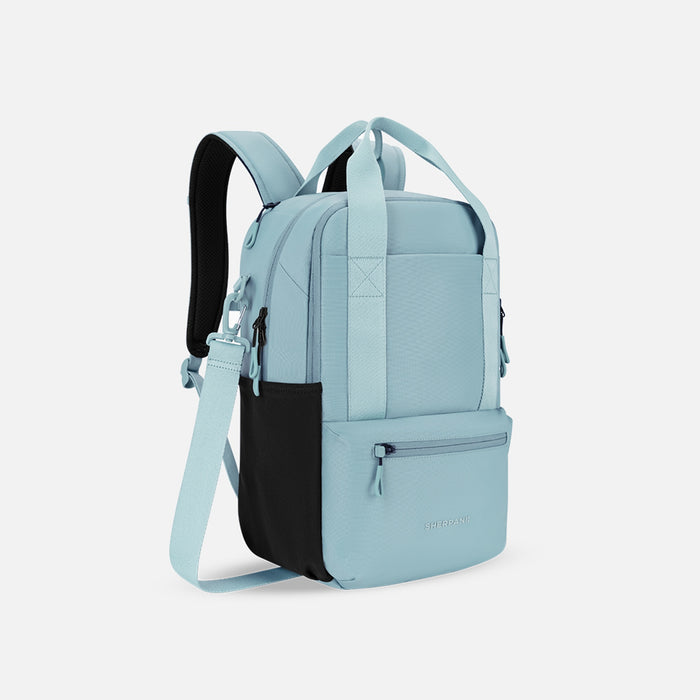 A Sherpani Camden Surf Blue Backpack, 3/4 view showing various pockets and strap options on white backdrop.  #color_surf-blue