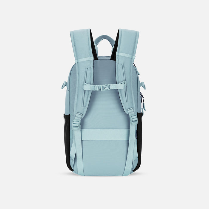 A Sherpani Camden Surf Blue Backpack, back view showing the shoulder strap and a luggage strap on a white background. #color_surf-blue