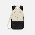 A Sherpani Camden Terrazzo Print Backpack, front view showing various pockets and strap options on white backdrop.  #color_terrazzo-print