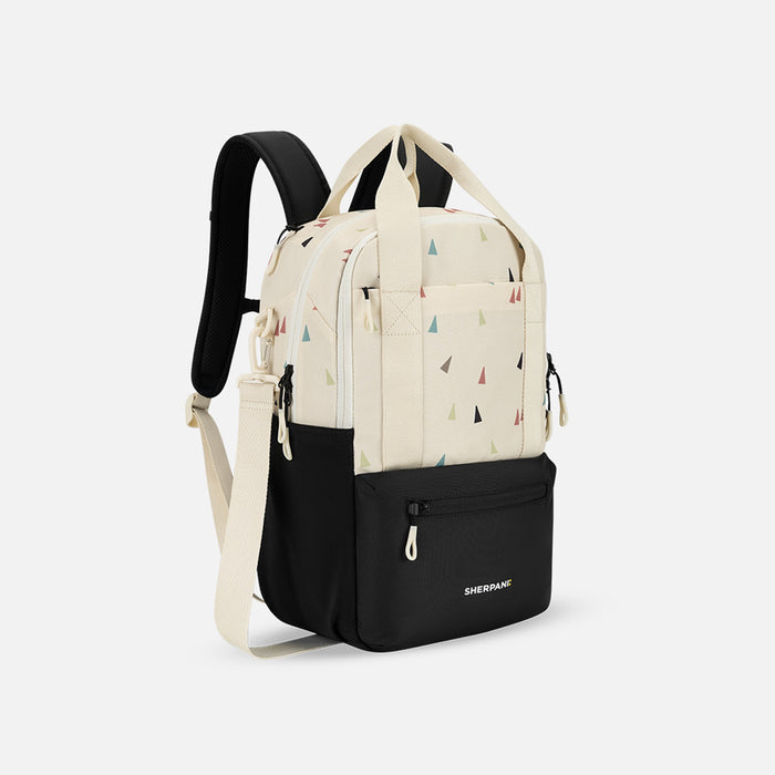 A Sherpani Camden Terrazzo Print Backpack, 3/4 view showing various pockets and strap options on white backdrop.  #color_terrazzo-print