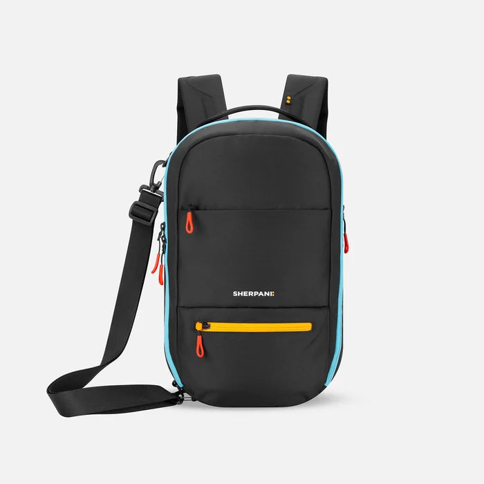 A Sherpani Camden Chromatic Black  Ultimate Backpack, front view showing various pockets and strap options on white backdrop.  #color_chromatic-black