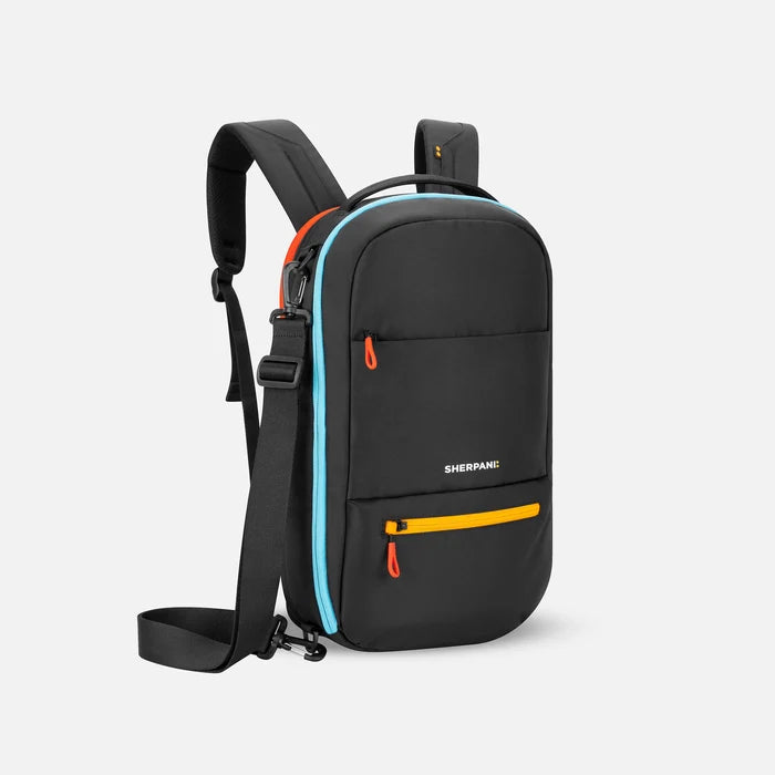 A Sherpani Camden Chromatic Black Ultimate Backpack, 3/4 view showing various pockets and strap options on white backdrop. #color_chromatic-black