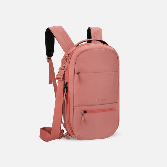 A Sherpani Camden Desert Pink Ultimate Backpack, 3/4 view showing various pockets and strap options on white backdrop. #color_desert-pink