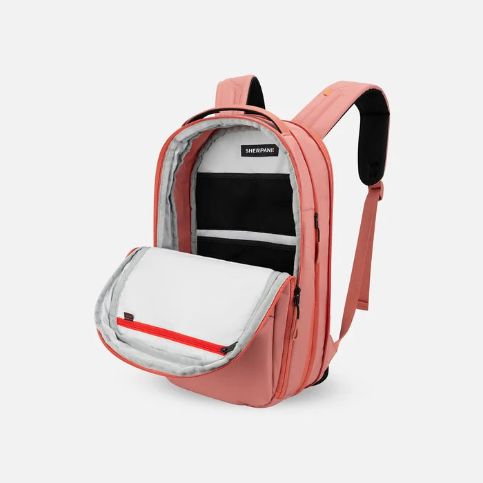 A Sherpani Camden Desert Pink Ultimate Backpack, 3/4 view showing inside of main pocket on a white background.    #color_desert-pink