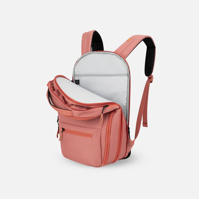 A Sherpani Camden Desert Pink Ultimate Backpack, 3/4 view showing inside of laptop pocket on a white background. #color_desert-pink