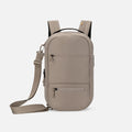 A Sherpani Camden Dune Ultimate Backpack, front view showing various pockets and strap options on white backdrop.  #color_dune-tan