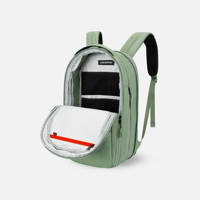 A Sherpani Camden Olivine Ultimate Backpack, 3/4 view showing inside of main pocket on a white background.    #color_olivine-green