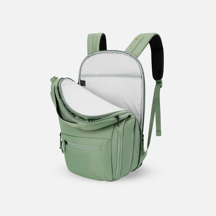 A Sherpani Camden Olivine Ultimate Backpack, 3/4 view showing inside of laptop pocket on a white background. #color_olivine-green