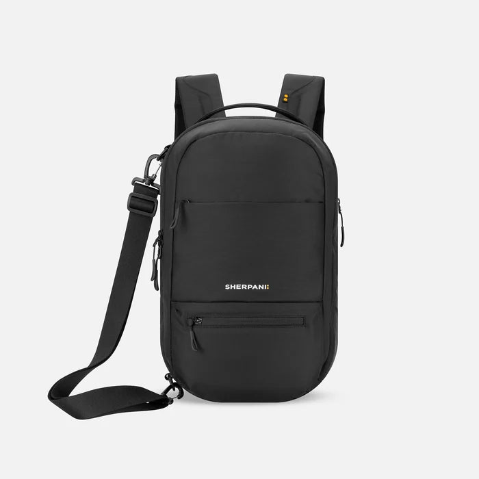A Sherpani Camden Raven Black Ultimate Backpack, front view showing various pockets and strap options on white backdrop. #color_raven-black