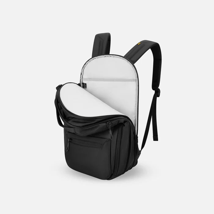 A Sherpani Camden Raven Black Ultimate Backpack, 3/4 view showing inside of laptop pocket on a white background. #color_raven-black
