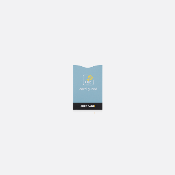 A Sherpani Passport Guard Blue RFID Sleeve on white backdrop.