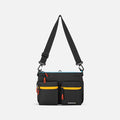 A Sherpani Ceara Chromatic Black Expandable Crossbody, front view showing two front pockets and adjustable strap on a white background.  #color_chromatic-black
