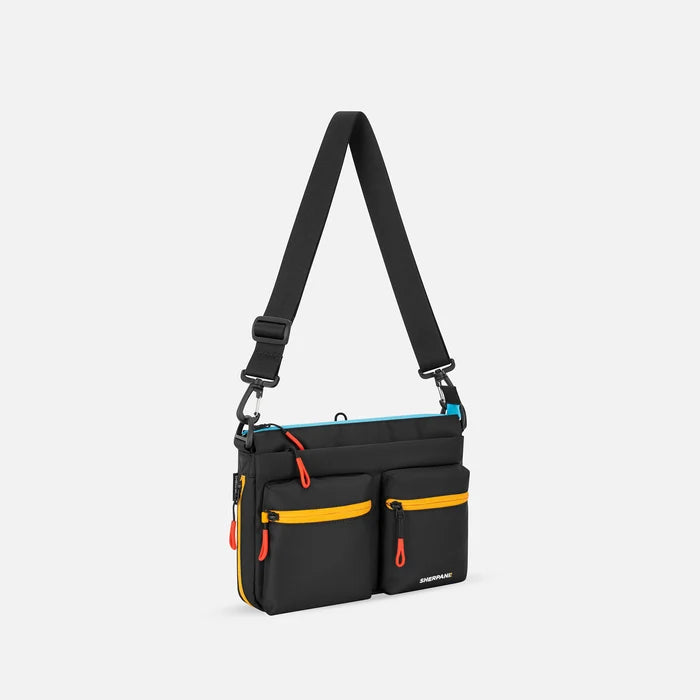 A Sherpani Ceara Chromatic Black Expandable Crossbody, 3/4 view showing two front pockets and the closed expandable pocket on a white background. #color_chromatic-black