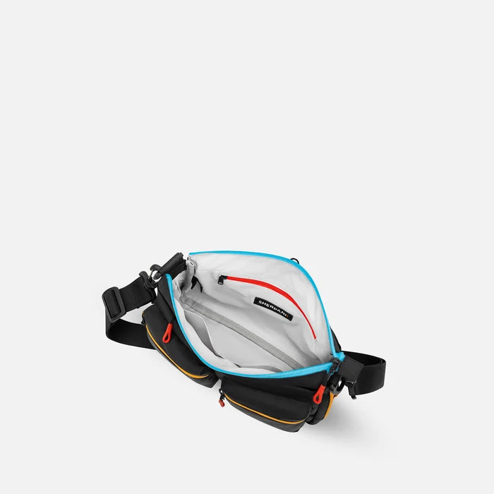 A Sherpani Ceara Chromatic Black Expandable Crossbody, above view showing all inside pockets on a white background.   #color_chromatic-black