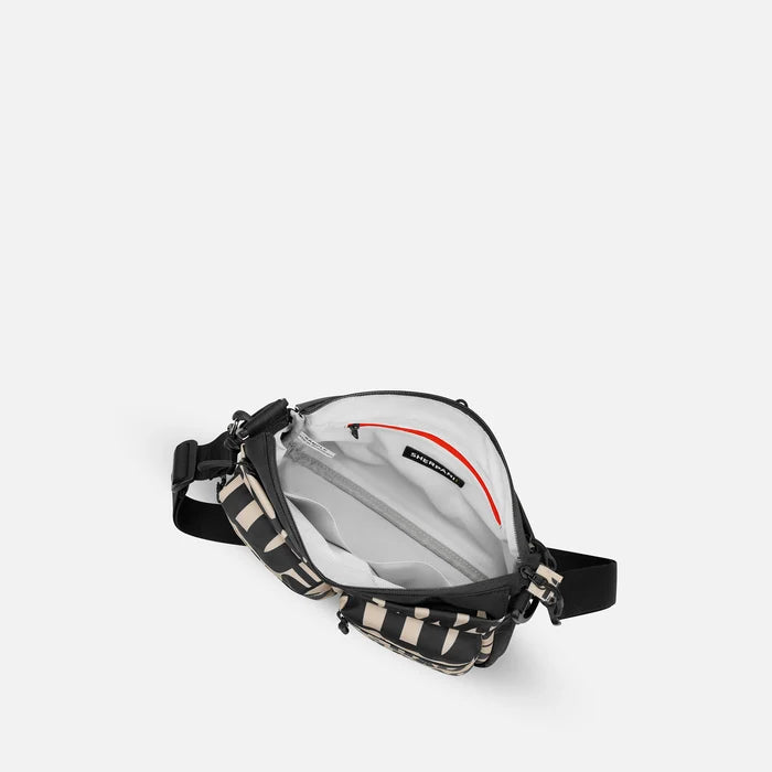 A Sherpani Ceara Ciao Expandable Crossbody, above view showing all inside pockets on a white background.   #color_ciao-print