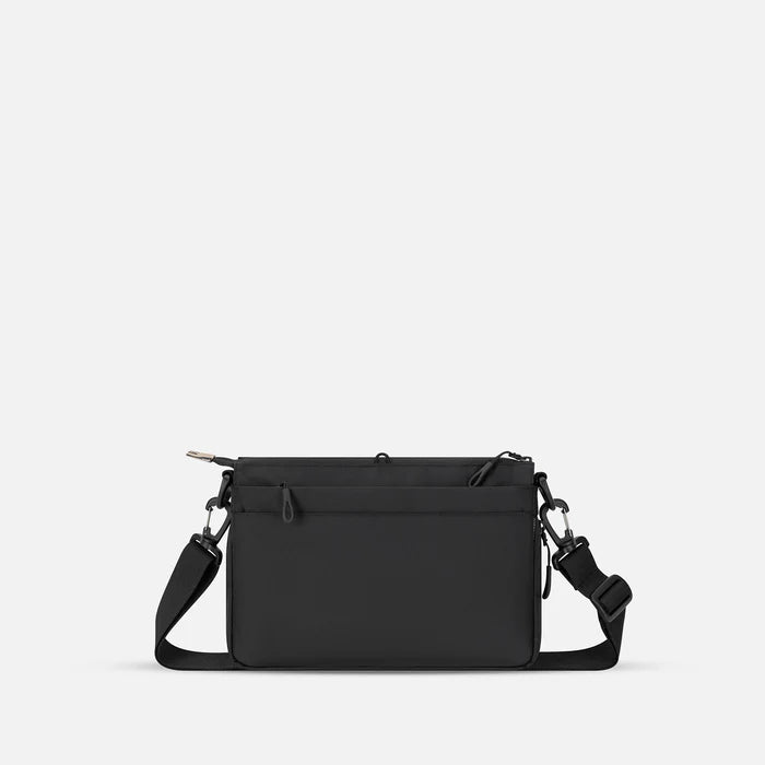A Sherpani Ceara Ciao Expandable Crossbody, back view showing the back pocket on a white background.   #color_ciao-print
