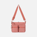 A Sherpani Ceara Desert Pink Expandable Crossbody, front view showing two front pockets and adjustable strap on a white background.  #color_desert-pink