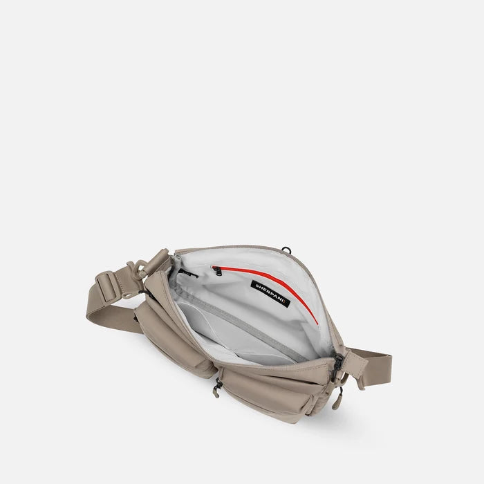 A Sherpani Ceara Dune Expandable Crossbody, above view showing all inside pockets on a white background.   #color_dune-tan