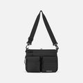 A Sherpani Ceara Raven Black Expandable Crossbody, front view showing two front pockets and adjustable strap on a white background.  #color_raven-black