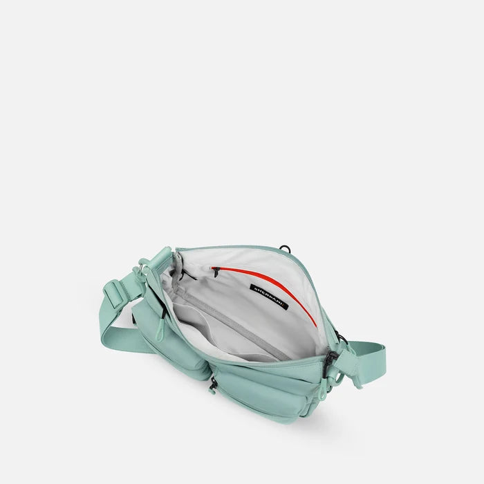 A Sherpani Ceara Surf Blue Expandable Crossbody, above view showing all inside pockets on a white background.   #color_surf-blue