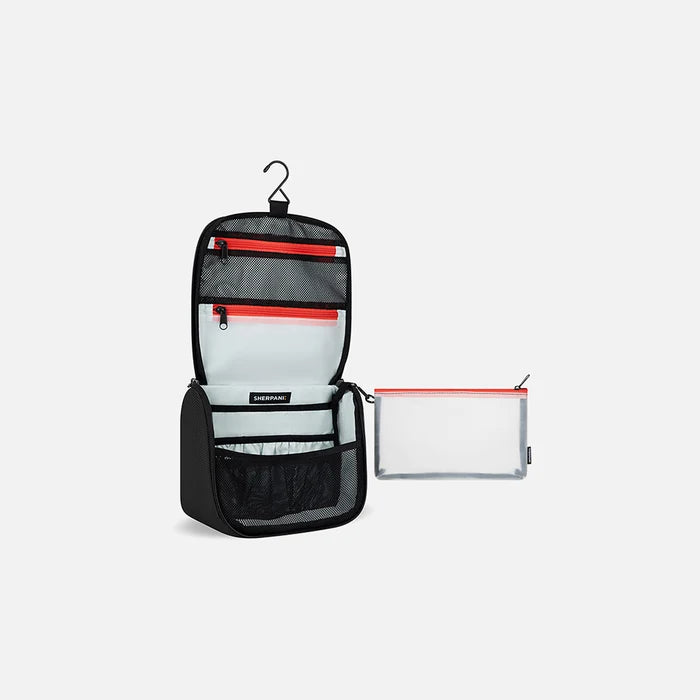 A Sherpani Co-Pilot Carbon Black Travel Toiletry Case, 3/4 view showing interior pockets  against white backdrop. #color_carbon-black