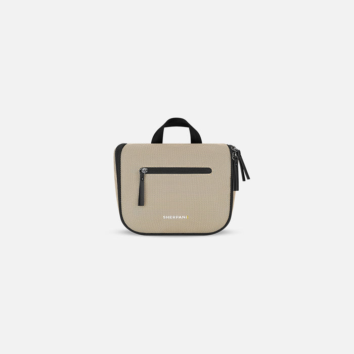 A Sherpani Co-Pilot Straw Beige Travel Toiletry Case, front view showing pockets and handle against white background.  #color_straw-beige